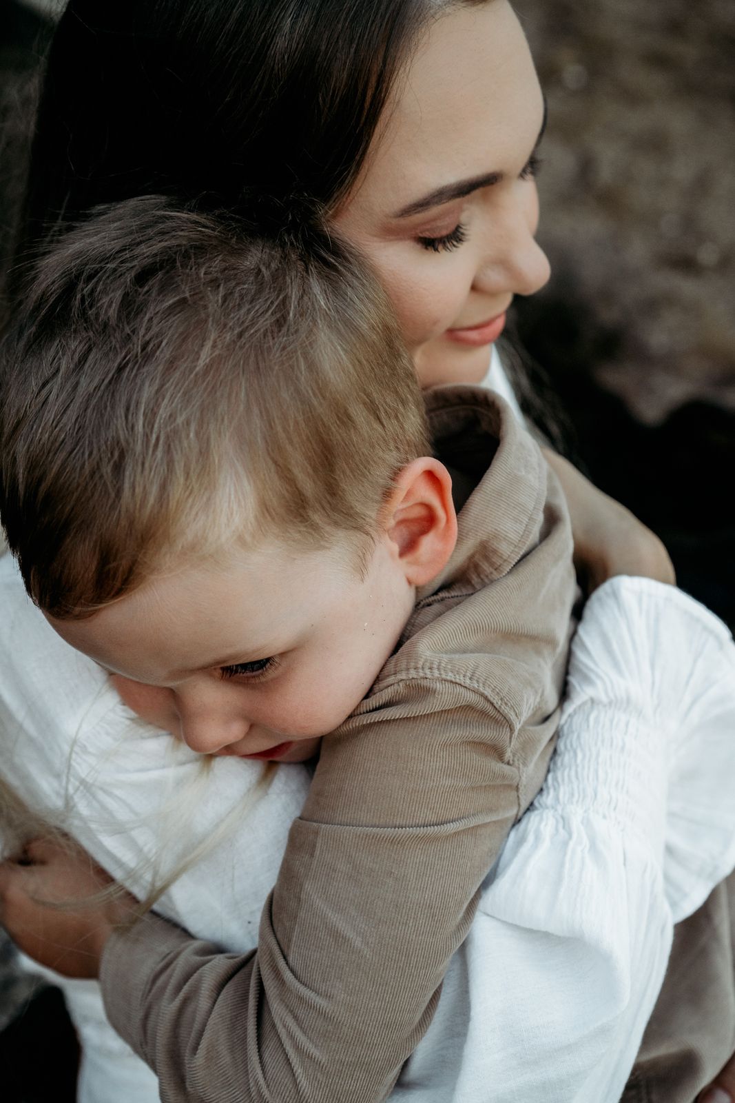 Mum hugging her little boy close